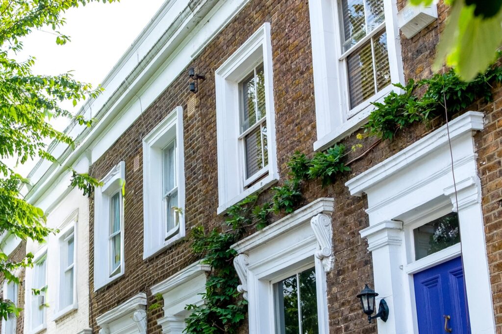 A row of Victorian terraced houses on a quiet English street, the kind of tenanted property sold off-market without a For Sale board